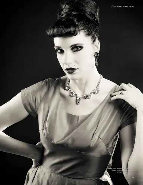 Black and white editorial beauty portrait with a sculpted updo.