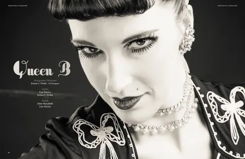 Black and white editorial close up with a sculpted updo and ornate collar.