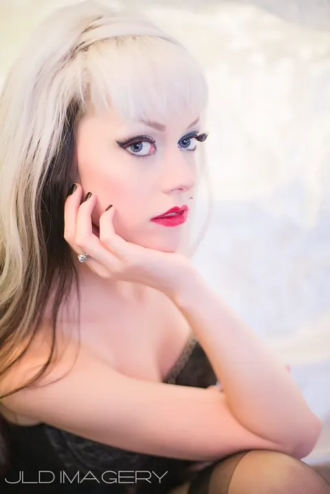 High-key beauty portrait with platinum hair and red lipstick.