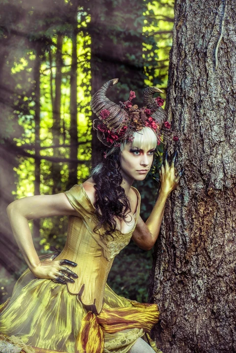 Woodland fantasy portrait with an elaborate horned floral headpiece.