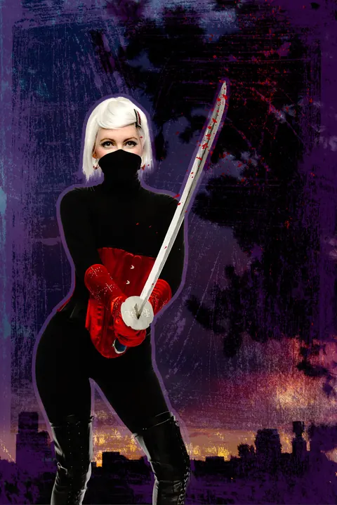Masked musician in black holding a red electric violin against a night city backdrop.