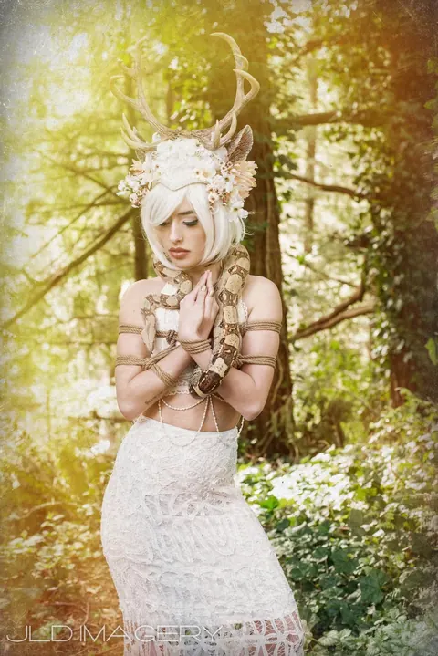 Woodland fantasy portrait in white with an ornate antlered headpiece.