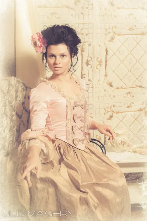 Period fashion portrait in a pale pink gown.
