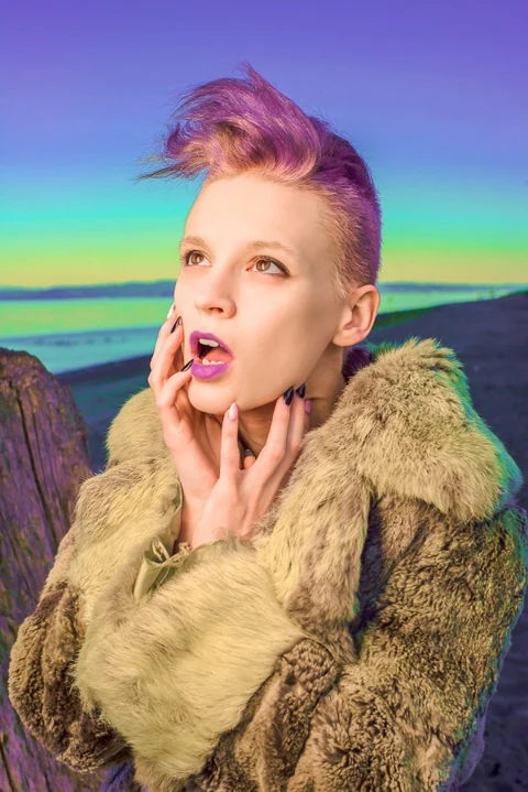Fashion portrait with a sculptural hairstyle and dramatic styling.