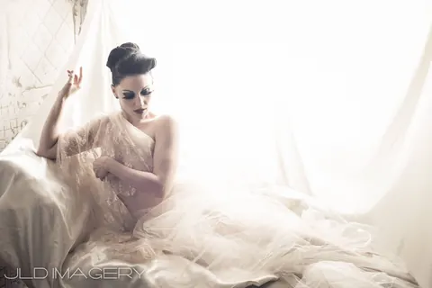 Bright reclining fashion portrait in white lace.