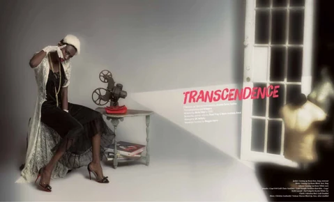 Editorial title spread "TRANSCENDENCE" in red brushwork font — Binta Diba seated in a long black lace dress and white feathered hat beside a vintage film projector beaming a beam of light across the spread, credits below the title.