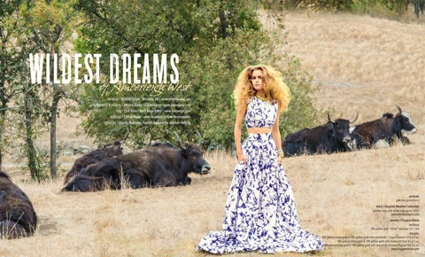 Editorial title spread "Wildest Dreams of Amberleigh West" with full credits — Amberleigh in a navy and white floral two-piece gown standing among reclining yaks in dry grass.